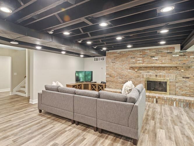 A remodeled basement in a Cleveland area home. Features need wood floors, a brick fireplace, and an industrial ceiling