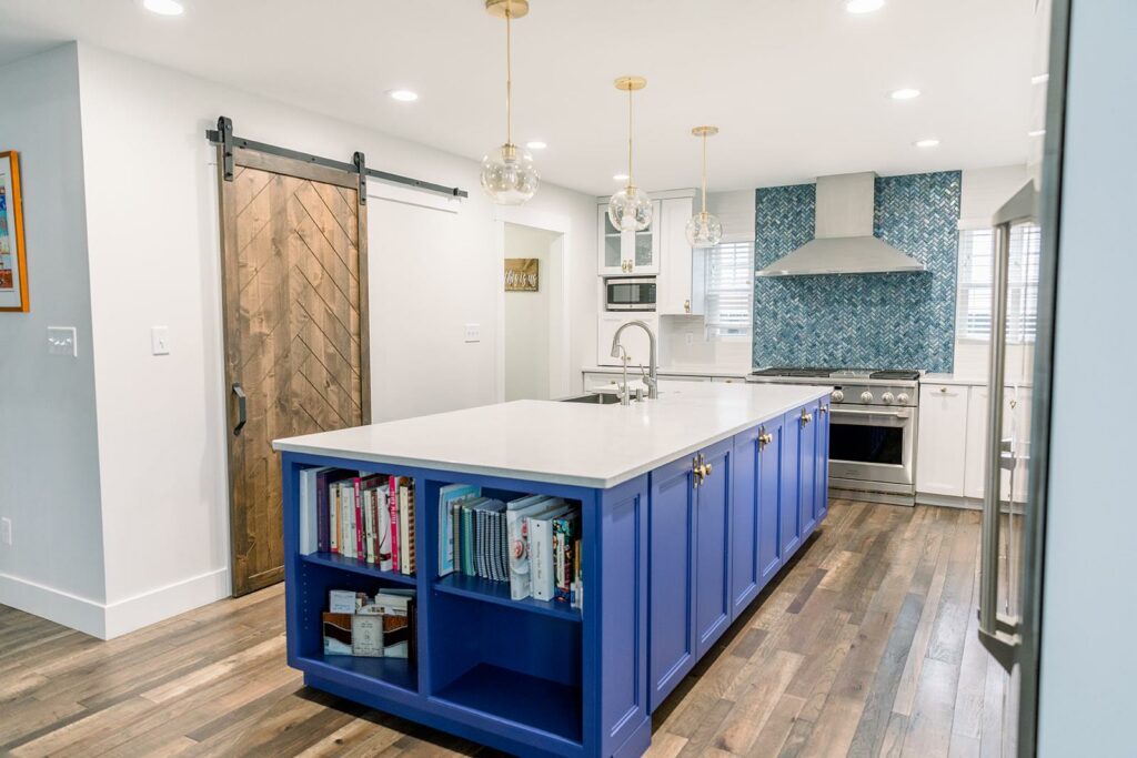 A bright blue kitchen island with built-in bookshelf. A stunning way to make bold use of color in your modern kitchen
