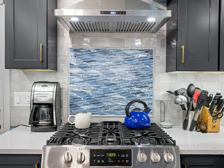 A geometric, blue and white tiled kitchen backsplash
