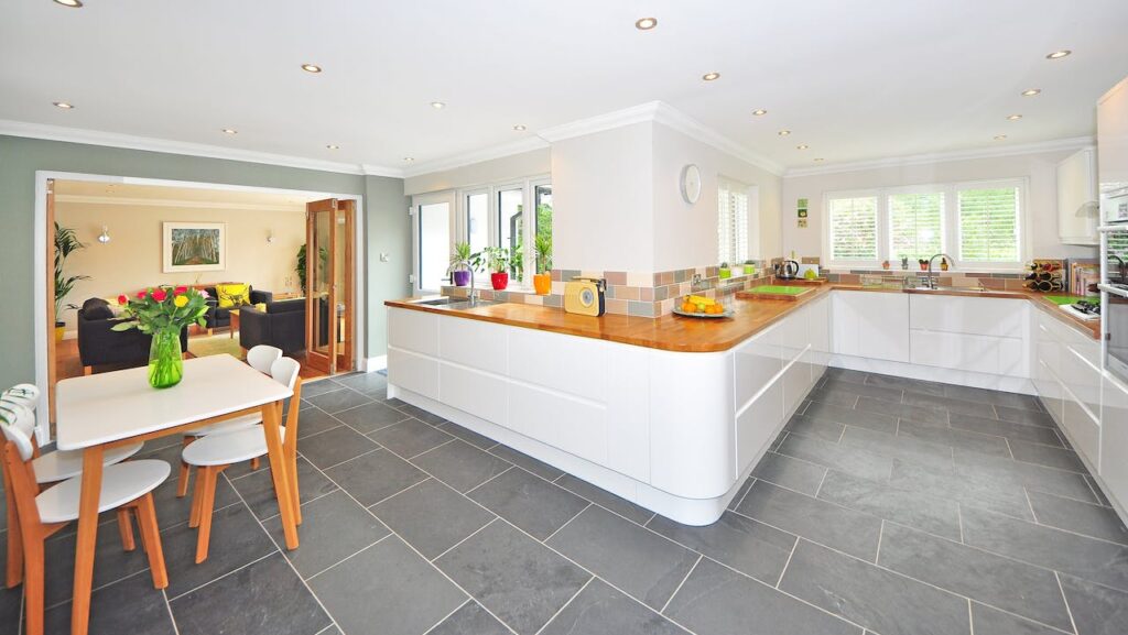 A modern kitchen with large format, slate tile flooring