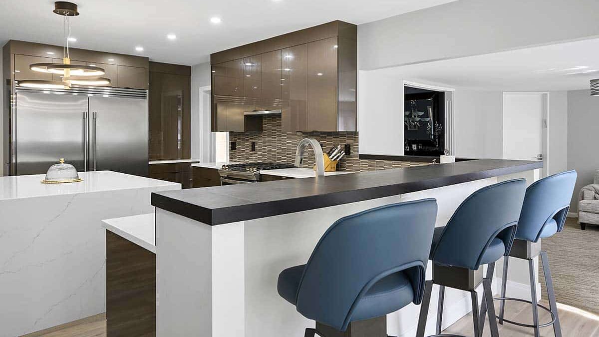 Comfortable blue chairs against a bar-style counter in a bright, modern kitchen