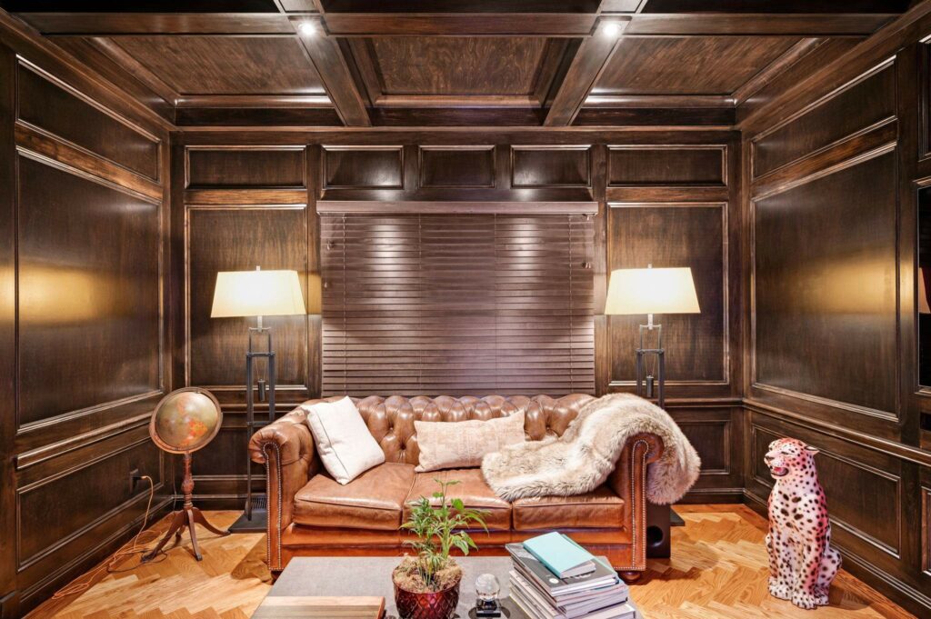 Sterncrest Moreland Hills Hideaway Remodel sofa with lights on either side and wood panels