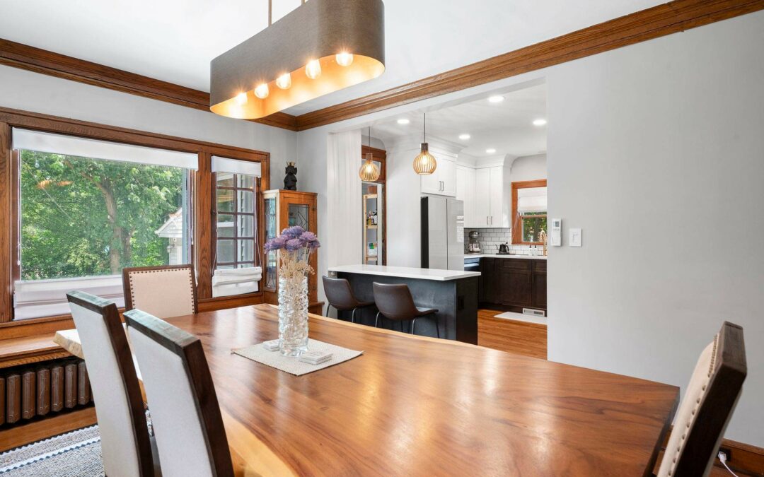 Keselman Group Home Remodel - living room with warm tones. Natural slab table with wood trim and white accents.