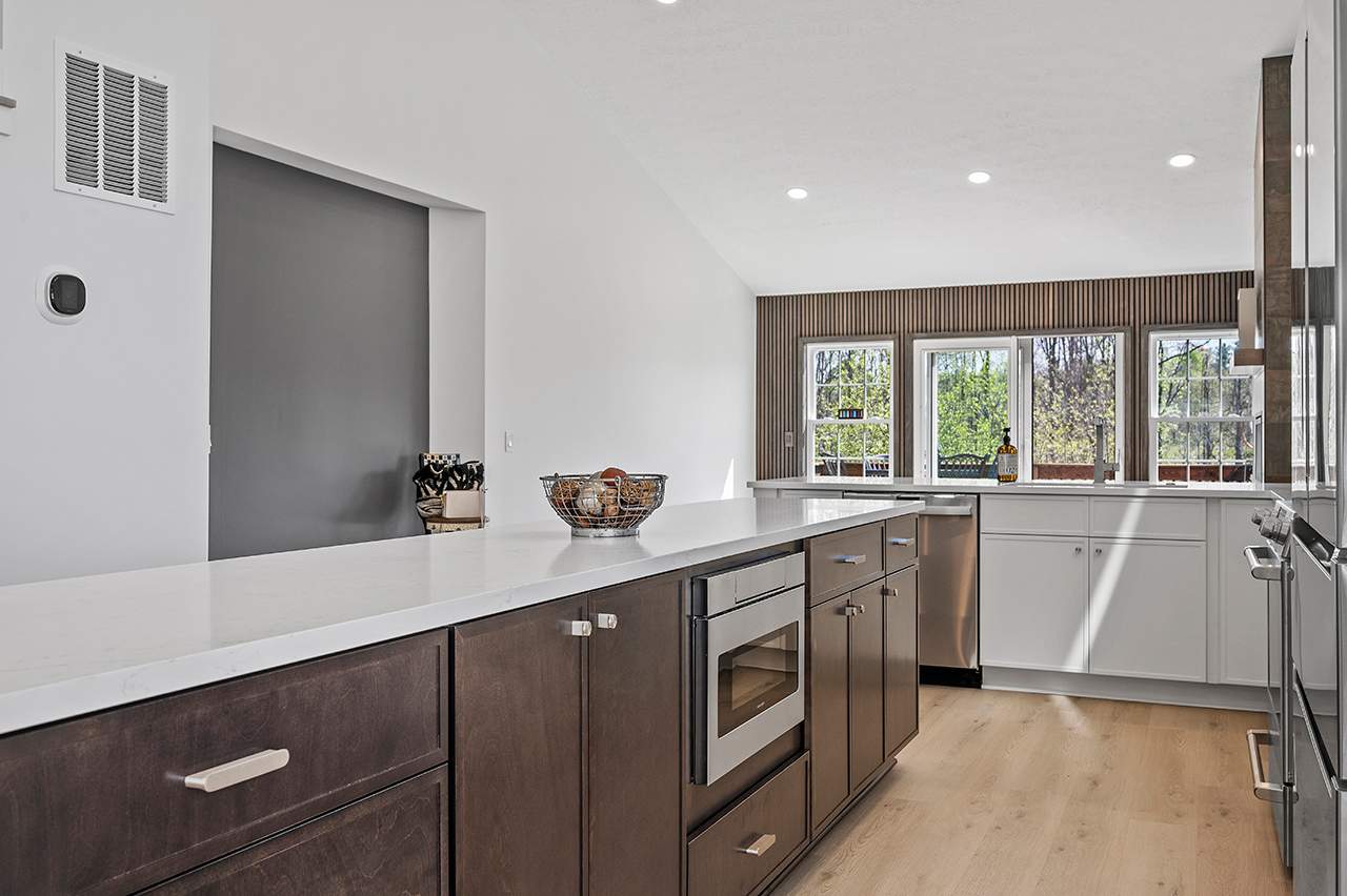 kitchen remodel in the Cleveland area. Counter tops. White walls. Dark brown hardwood caibnets.